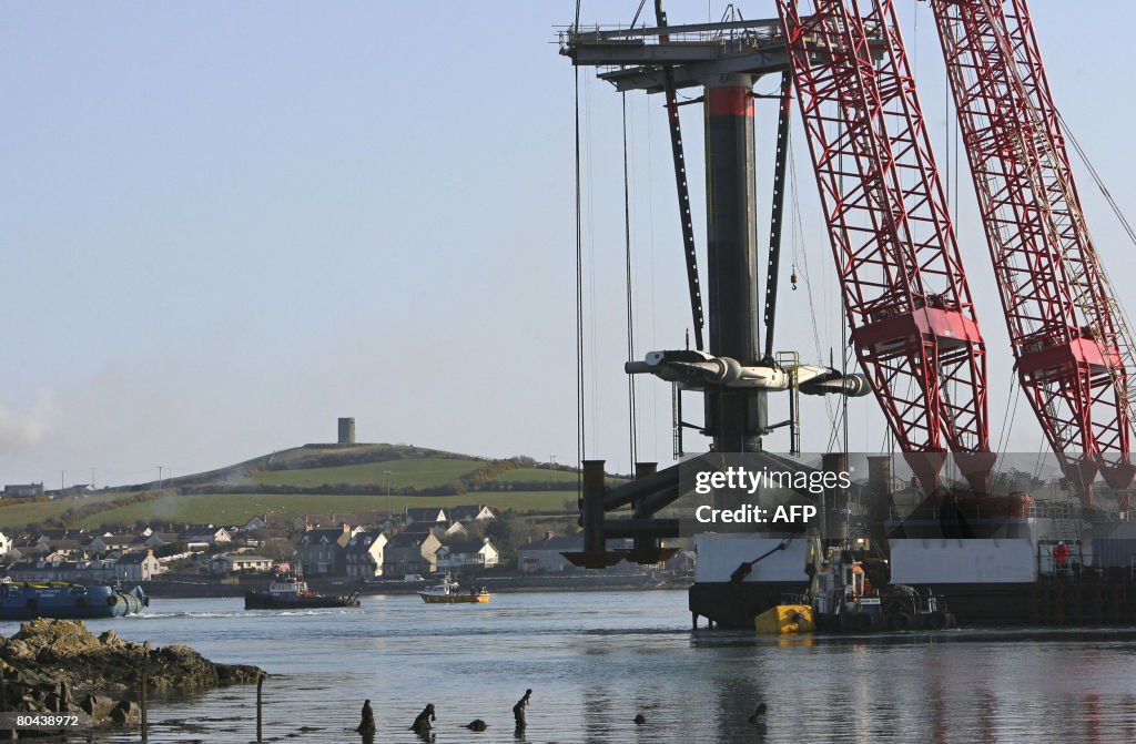 A barge tows a 122ft inverted windmill c