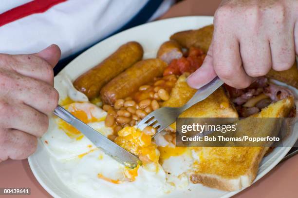 Close-up of a man eating a full English breakfast served at a cafe in the seaside resort of Blackpool, in Northwest England, 28th August 2007.