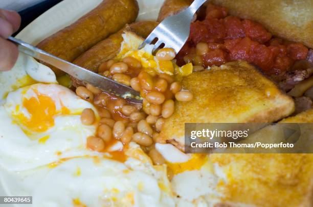 Full English breakfast being eaten at a cafe in the seaside resort of Blackpool, in Northwest England, 28th August 2007.