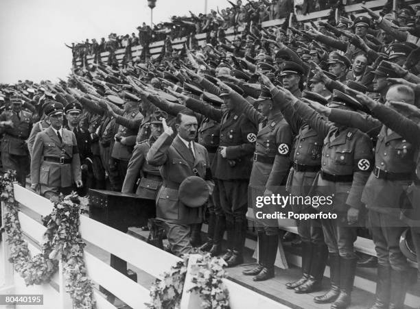 Nazi leader Adolf Hitler salutes the crowds at the Nuremberg Rally marking the 6th Party Congress of the Nazi Party, September 1934 .