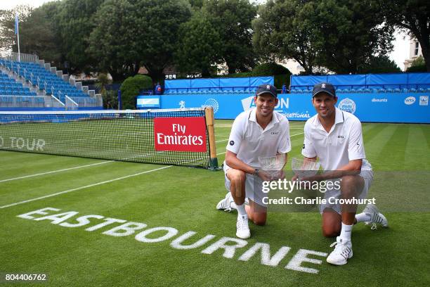 Bob and Mike Bryan pose for a photo with their trophies after winning there mens doubles final match against Rohan Bopanna and Andre Sa on day 6 of...