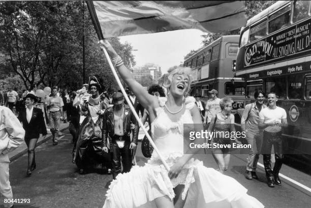 Marcher carrying a rainbow flag during the annual Gay Pride march in London, London, 18th June 1994.