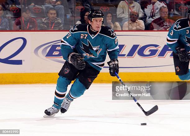 Center Jeremy Roenick of the San Jose Sharks skates the puck up ice against the Phoenix Coyotes on March 25, 2008 at Jobing.com Arena in Glendale,...