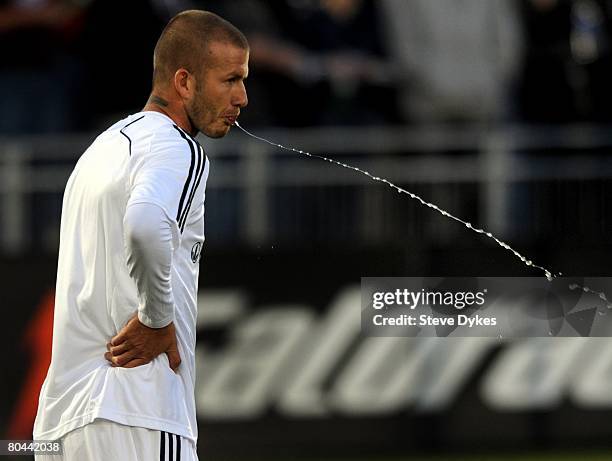 David Beckham of the Los Angeles Galaxy spits out some water during warmups before the MLS soccer game against the Colorado Rapids at Dick's Sporting...