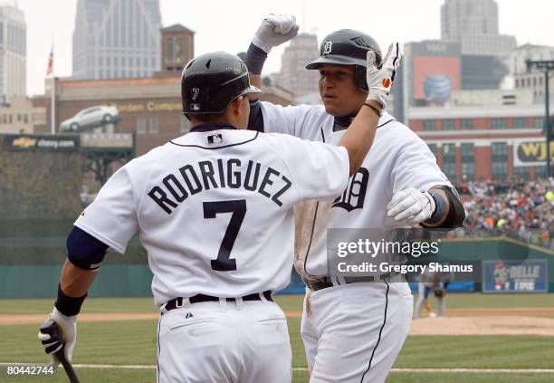 Miguel Cabrera of the Detroit Tigers is congratulated by Ivan Rodriguez after Cabrera scored on his solo home run in the bottom of the fifth inning...