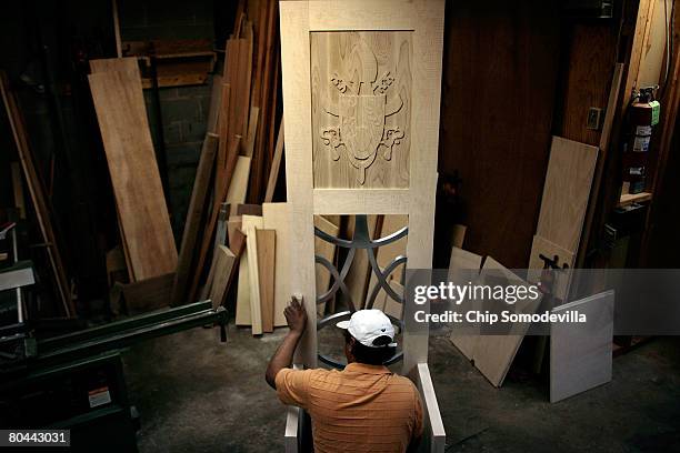 Carpenter Carlos Hernandez sands the chair that will be used by Pope Benedict XVI during his visit to Washington, DC, at Catholic Deacon Dave...