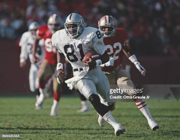 Tim Brown, Wide Receiver for the Los Angeles Raiders runs the ball during the National Football Conference West game against the San Francisco 49ers...