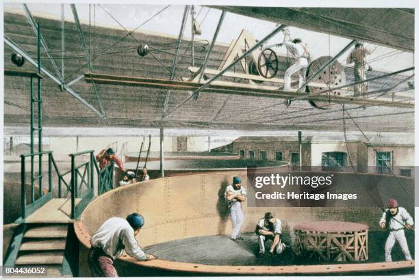 Manufacturing the transatlantic telegraph cable, c1865 . Coiling the telegraph cable in the tanks at the works in Greenwich. The cable, connecting...