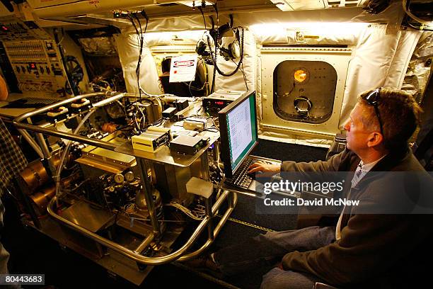 National Center for Atmospheric Research scientist Andy Weinheimer makes final adjustments to equipment for measuring active nitrogen in ozone aboard...
