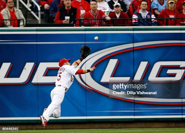 Skip Schumaker of the St. Louis Cardinals dives to make the catch for the out against the Colorado Rockies during Opening Day at Busch Stadium March...