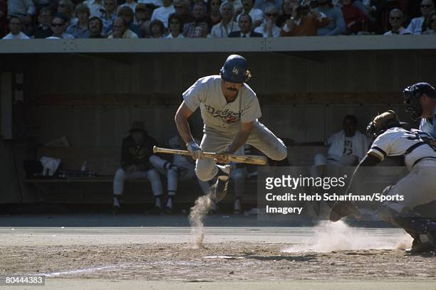 Bill Buckner of the Los Angeles Dodgers jumps out of the way of a ball against the Pittsburgh Pirates during Game 2 of the National League...