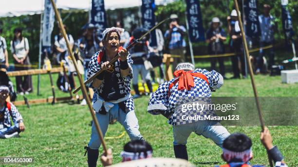 two senior men fighting by katana sword in japan - calancói imagens e fotografias de stock