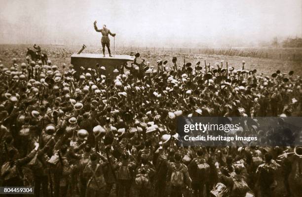 Colonel and men of the 9th East Surrey Regiment cheering the King, France, 12 November, 1918. Near Bavay, the day after the end of the First World...