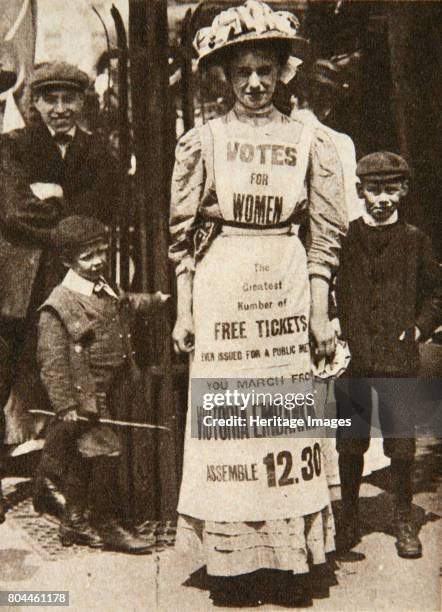 The suffragette housemaid, 1908. A suffragette wearing a pinafore advertising a protest on London's Victoria Embankment. The campaign to secure the...