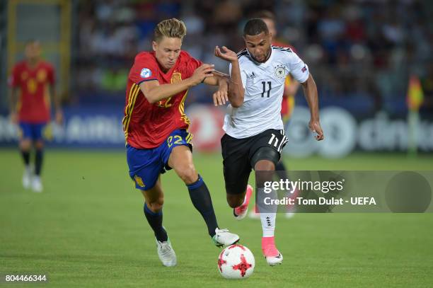 Marcos Llorente of Spain holds off Serge Gnabry of Germany during the UEFA European Under-21 Championship Final between Germany and Spain at Krakow...