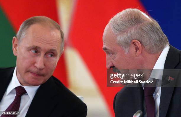Russian President Vladimir Putin listens to President of Belarus Alexander Lukashenko during the Supreme State Council of Russia and Belarus at the...