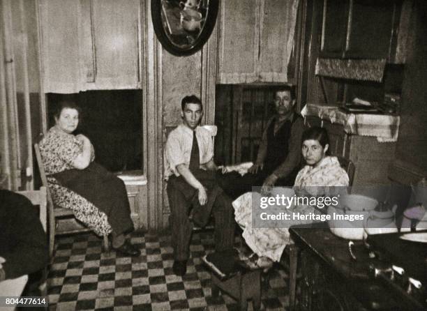 Residents of a tenement, Henry Street, Lower East Side, Manhattan, New York, USA, early 1930s. The Lower East Side was a predominantly immigrant,...
