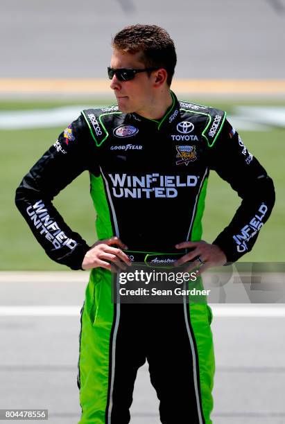 Dakoda Armstrong, driver of the WinField United Toyota, stands on the grid during qualifying for the NASCAR XFINITY Series Coca-Cola Firecracker 250...