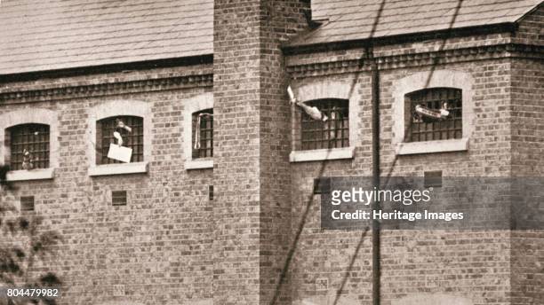 Hunger strikers waving to Christabel Pankhurst from their cells in Holloway Prison, London, 1909. The fourteen suffragettes went on hunger in protest...