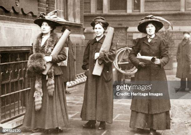 Suffragettes armed with materials to chain themselves to railings, 1909. The Suffragettes found that by chaining themselves to railings they could...