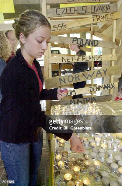 Washington University student Melissa Fishkin from Brooklyn, New York, lights a Yurzeit candle April 19, 2001 during Holocaust Memorial Day, in St....