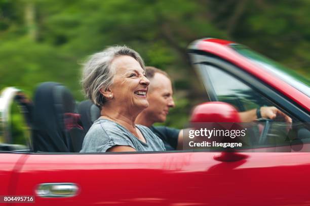 mother and son in a convertible - red car stock pictures, royalty-free photos & images