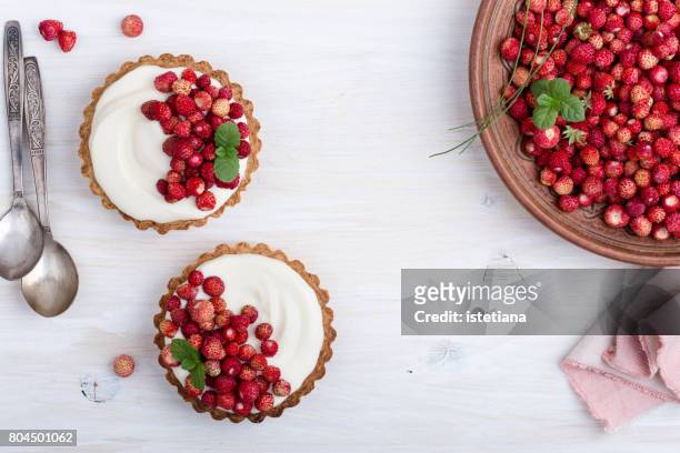 wild strawberry mini tarts with cream filling - tart dessert stock pictures, royalty-free photos & images