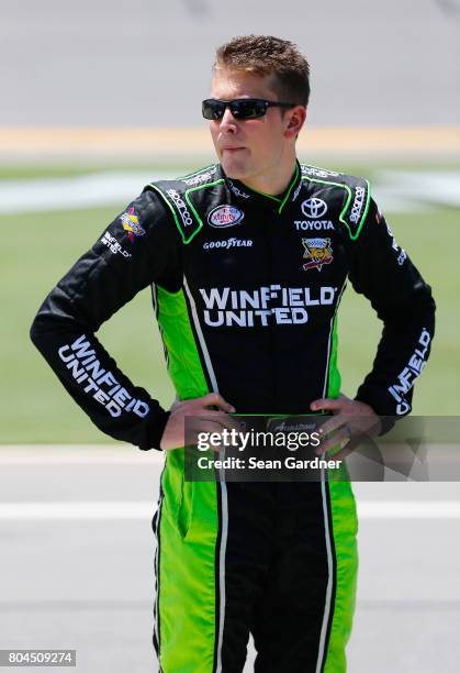 Dakoda Armstrong, driver of the WinField United Toyota, stands on the grid during qualifying for the NASCAR XFINITY Series Coca-Cola Firecracker 250...