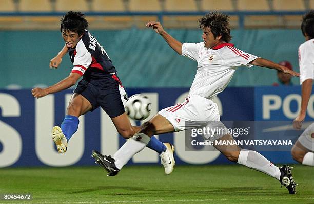 In this picture taken November 29 Indian football captain Bhaichung Bhutia is tackled by Hong Kong's Lin Jun Sheng during their men's second round...