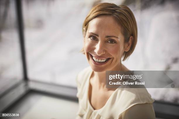 portrait of smiling woman wearing braces - blonde hair brown eyes stock pictures, royalty-free photos & images