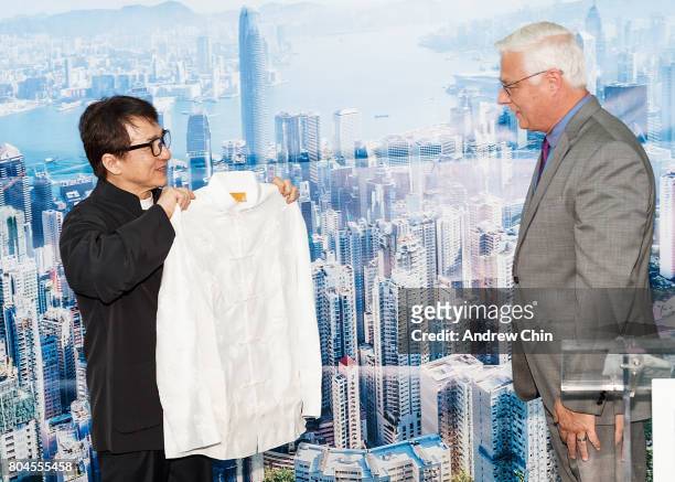 Actor and martial artist Jackie Chan gives a gift to President and CEO of Vancouver Airport Authority Craig Richmond during the celebration of Hong...
