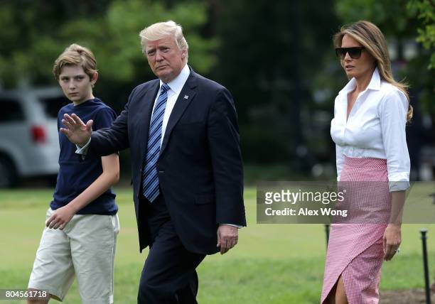 President Donald Trump, first lady Melania Trump and son Barron Trump walk on the South Lawn prior to a Marine One departure at the White House June...