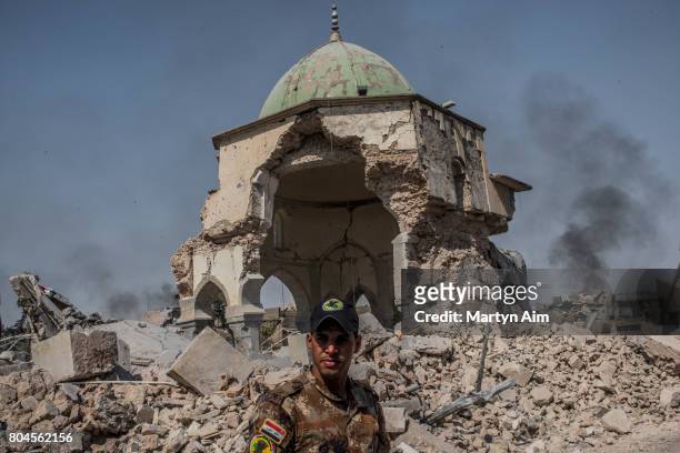 An Iraqi ISOF forces soldier in front of the destroyed al-Nuri mosque in the Old City of west Mosul where heavy fighting continues on June 30, 2017...
