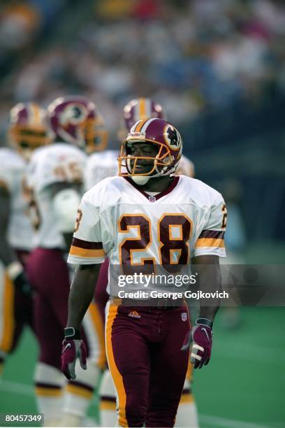 Defensive back Darrell Green of the Washington Redskins smiles while on the field during a preseason game against the Pittsburgh Steelers at Three...
