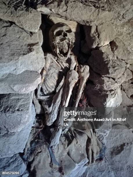 The skeleton of an Inca mummy lies in a cave on Cerro Volcano Tunupa overlooking the northern shore of the Salar de Uyuni, the largest salt flat in...