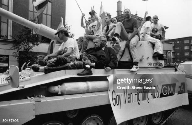 Tank on the annual Gay Pride march, London, carrying 'Gay Men Fighting AIDS' supporters, 24th June 1995. The vehicle is an FV433 Abbot self-propelled...