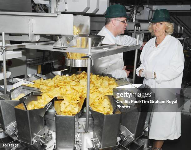 Camilla, Duchess of Cornwall is given a tour of the factory by Managing Director Les Sayers, during a visit to Tyrrells potato chip factory on March...