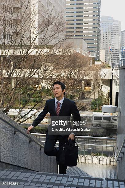 businessman running up stairs - 階段　のぼる ストックフォトと画像