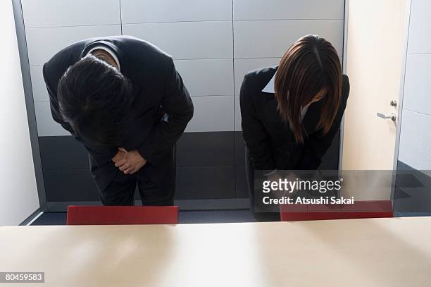 two business people bowing - お辞儀 ストックフォトと画像