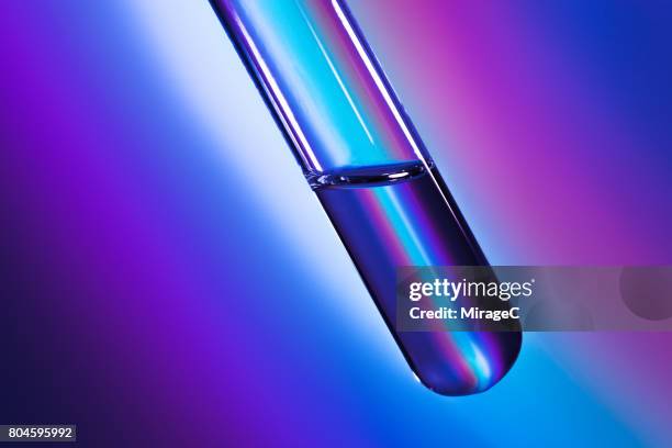 test tube against spectrum background - solutions chemistry stock pictures, royalty-free photos & images