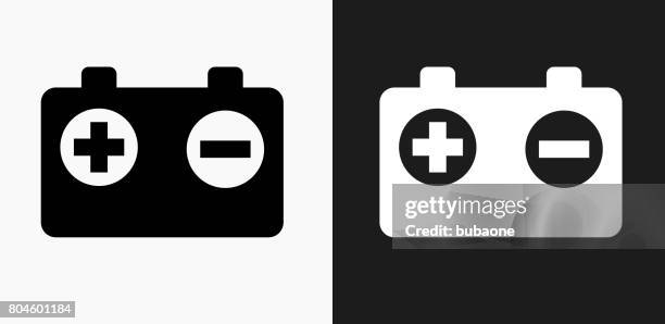 battery icon on black and white vector backgrounds - electrical engineers stock illustrations
