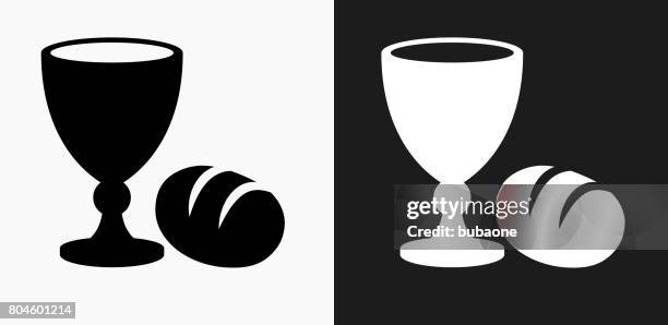 goblet and bread icon on black and white vector backgrounds - bread stock illustrations
