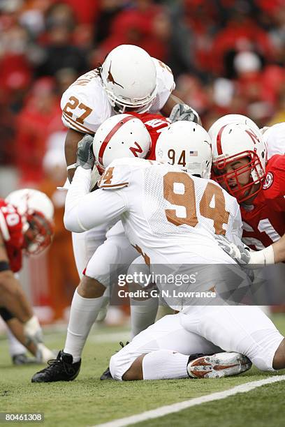 Quarterback Zac Taylor of Nebraska is sacked by Michael Griffin and Thomas Marshall during action between the Texas Longhorns and Nebraska...