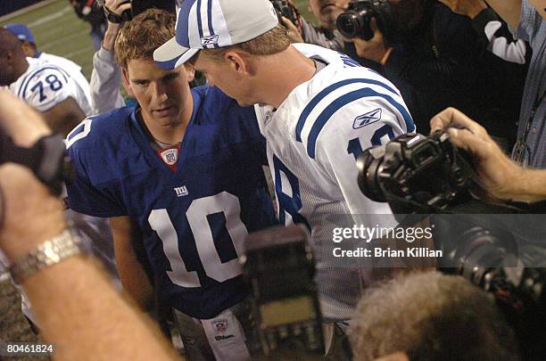 Indianapolis Colts quarterback Peyton Manning meets his brother New York Giants quarterback Eli Manning at midfield after the season opening game on...