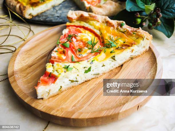 slice of homemade tomato pie, pizza or quiche with curd cheese, eggs and fresh chopped parsley on a wooden plate perfect for summer picnic or snack, selective focus - quiche stock pictures, royalty-free photos & images