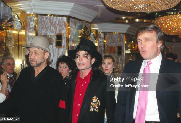 Businessman Donald Trump walks through Taj Mahal Casino Hotel at grand opening with pop star Michael Jackson in April 1990 in Atlantic City, New...
