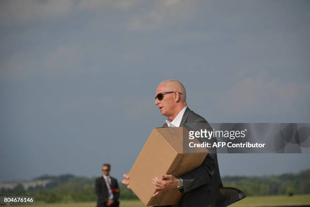 Keith Schiller,Director of Oval Office Operations, steps off off Air Force One carrying a box upon arrival in Morristown, New Jersey on June 30,...