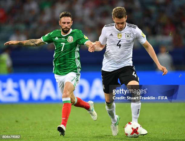 Matthias Ginter of Germany is challenged by Miguel Layn of Mexico during the FIFA Confederations Cup Russia 2017 semi final match between Germany and...