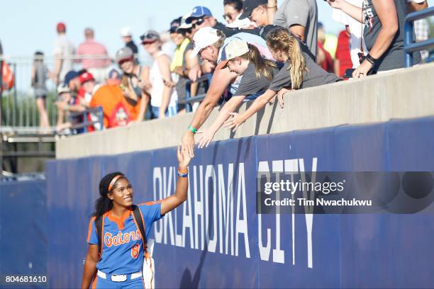 Aleshia Ocasio of the University of Florida high fives fans during Game 2 of the Division I Women's Softball Championship held at ASA Hall of Fame...