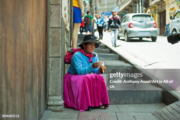 Local woman eating ice-cream on November, 2016 in La Paz, Bolivia.